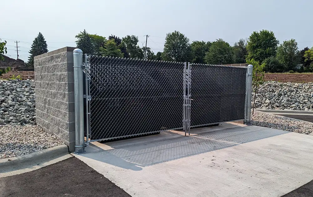 chain link fencing around a dumpster enclosure at a commercial location in Oshkosh, WI.